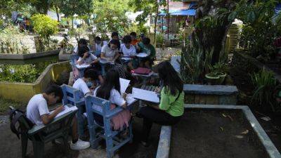 Students meet under trees as schools shelter villagers displaced by Philippine volcano - apnews.com - Philippines - province Albay