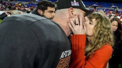 Taylor Swift greets Super Bowl-bound Travis Kelce with a kiss