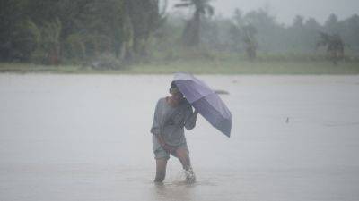 Deadly storm blows away from northern Philippines, but forecasters warn it may do a U-turn