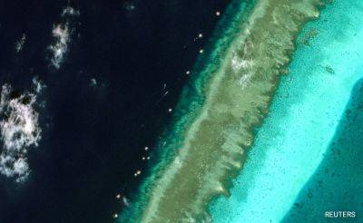 Satellite Images Show Floating Barrier At Disputed South China Sea Reef