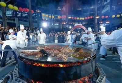 Giant Paella, eat-all-you-can barbecue pool party usher in summer
