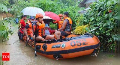 Storm floods northern Philippine regions, including capital, disrupting schools, work and travel - timesofindia.indiatimes.com - Philippines - province Samar - province Bulacan - province Quezon - city Manila - city Naga